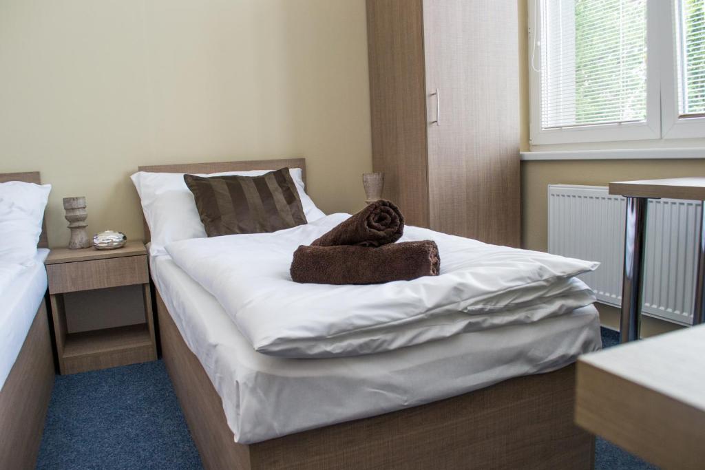Postel nebo postele na pokoji v ubytování Penzion s wellness Uherské Hradiště