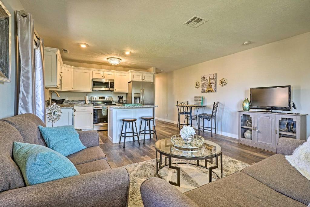 a living room with a couch and a table at Modern St George Getaway with Shared Pool and Hot Tub! in St. George
