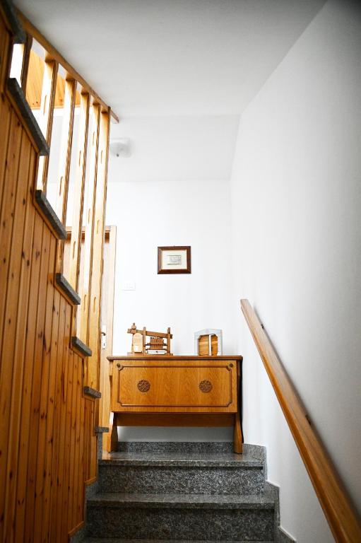a stairway with a wooden dresser in a room at Apartma Čuk in Dutovlje