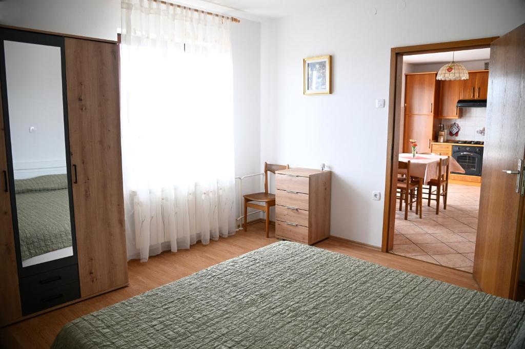 a bedroom with a door leading to a dining room at Apartma Čuk in Dutovlje
