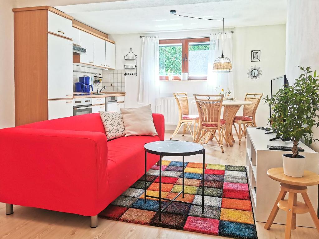 a living room with a red couch and a colorful rug at flex living - Business- und Ferienwohnung Wassermann in Dresden