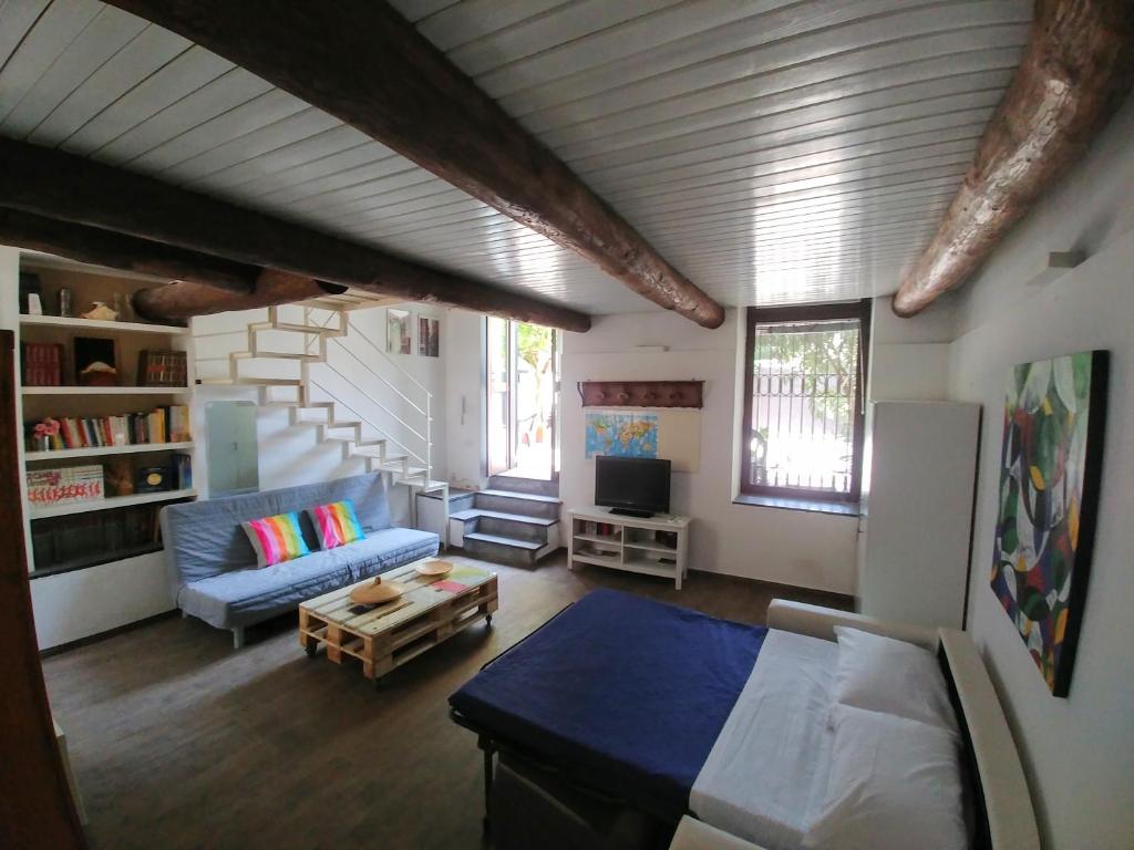 salon z niebieską kanapą i schodami w obiekcie Asso Di Coppa w mieście Scafati