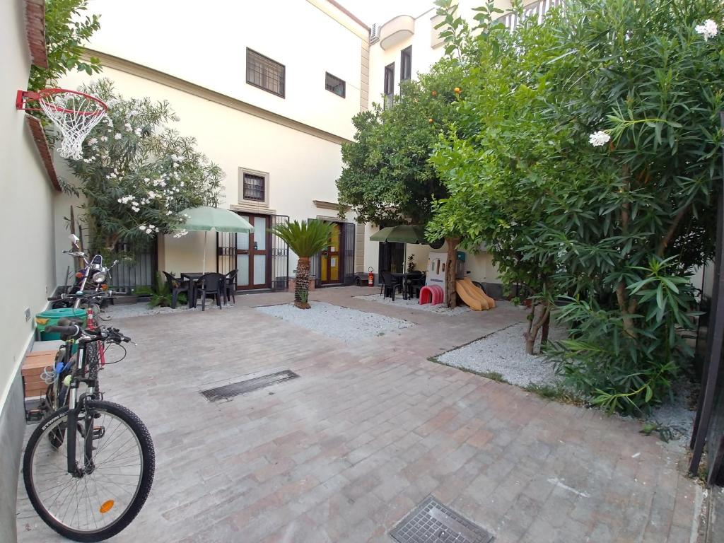 a bike parked next to a courtyard with trees at Asso Di Coppa in Scafati
