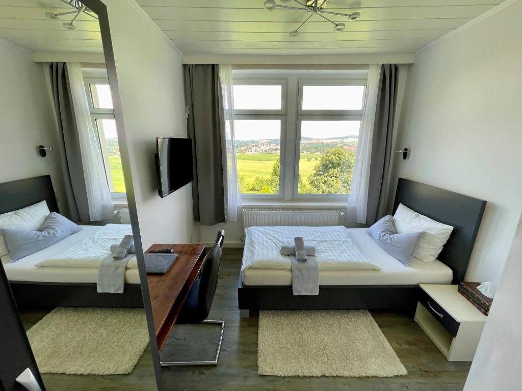 Postel nebo postele na pokoji v ubytování Waldhaus Pulsnitz