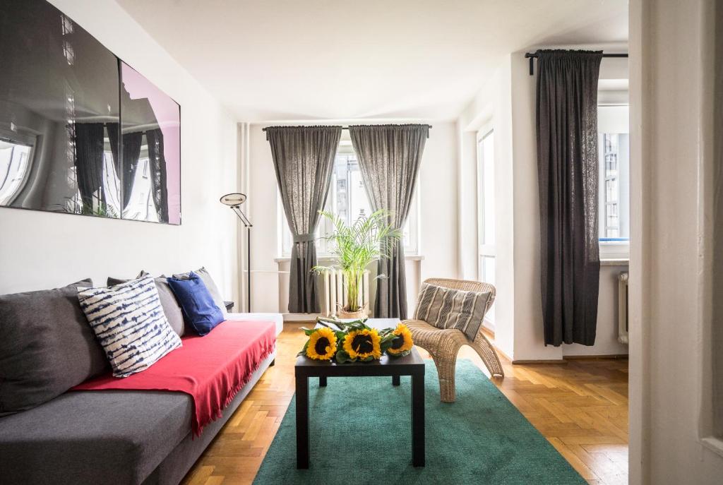 a living room with a couch and a table at oompH Warsaw Central 3-bedroom Flat in Warsaw