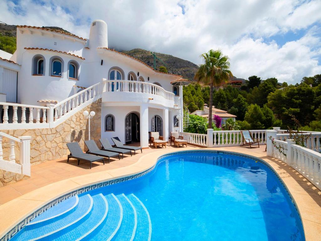 a villa with a swimming pool in front of a house at Villa Mona Lisa by Interhome in Altea