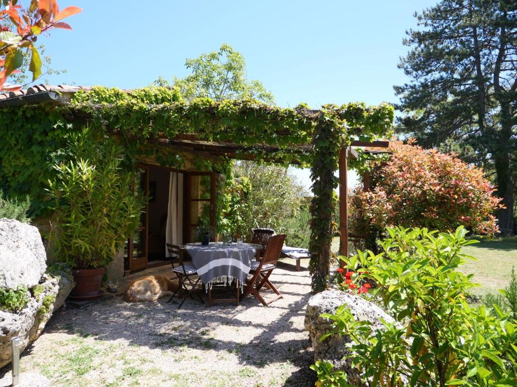 una mesa y sillas bajo una pérgola en un jardín en Holiday Home Fiore by Interhome, en Boccheggiano