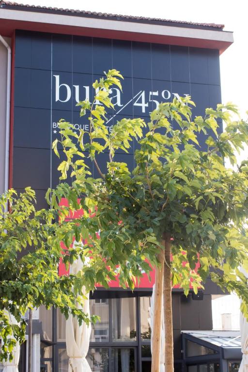 a building with a clock on the side of it at Boutique Hotel Bura 45N in Senj