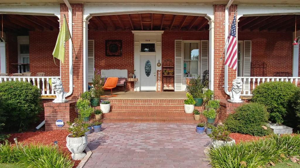 a brick house with an american flag on the porch at Fruits of Vienna B&B in Vienna
