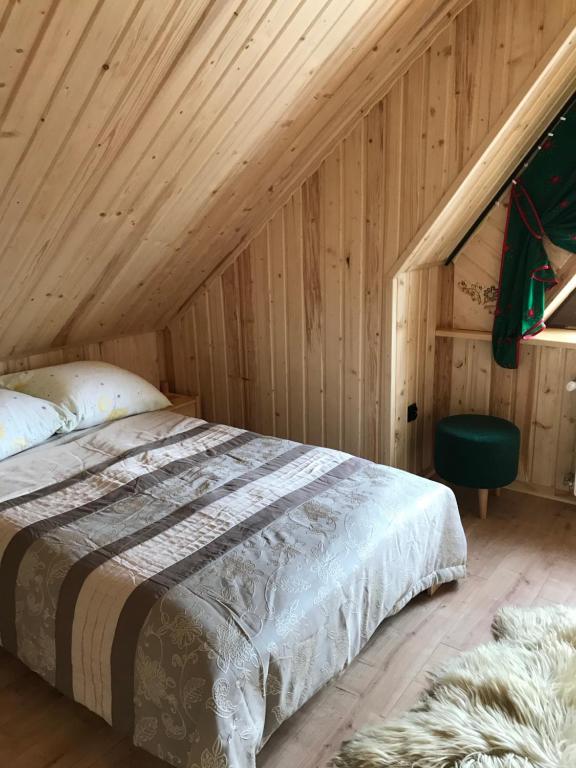 a bedroom with a bed in a wooden ceiling at Apartament u Beaty i Heńka, Łapszanka in Łapszanka