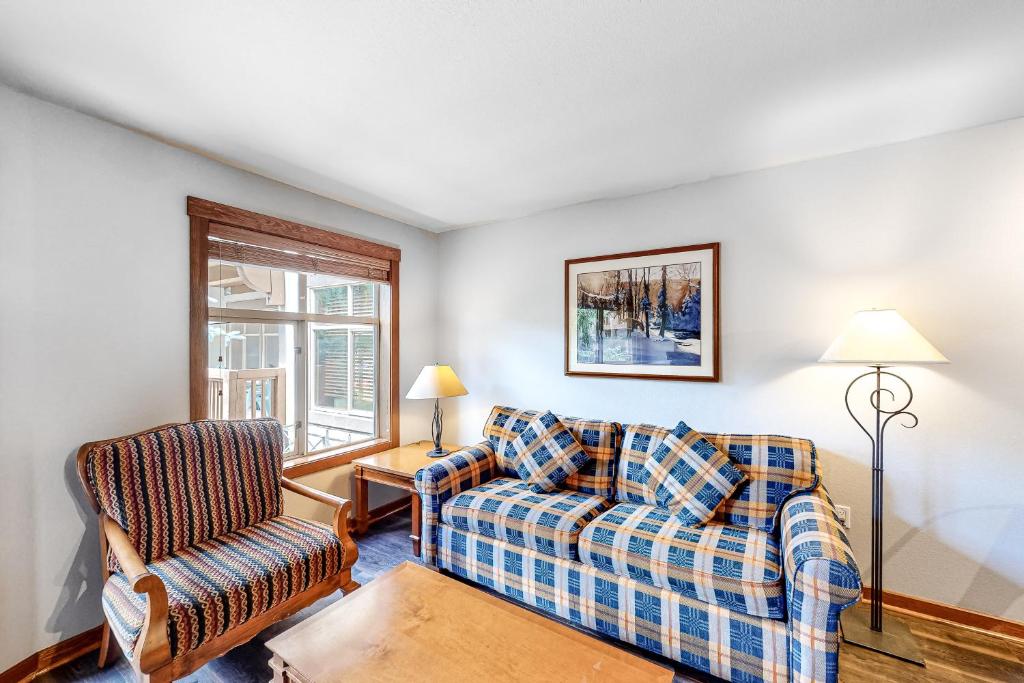 a living room with a couch and a chair at Powderhorn Lodge 209 in Solitude