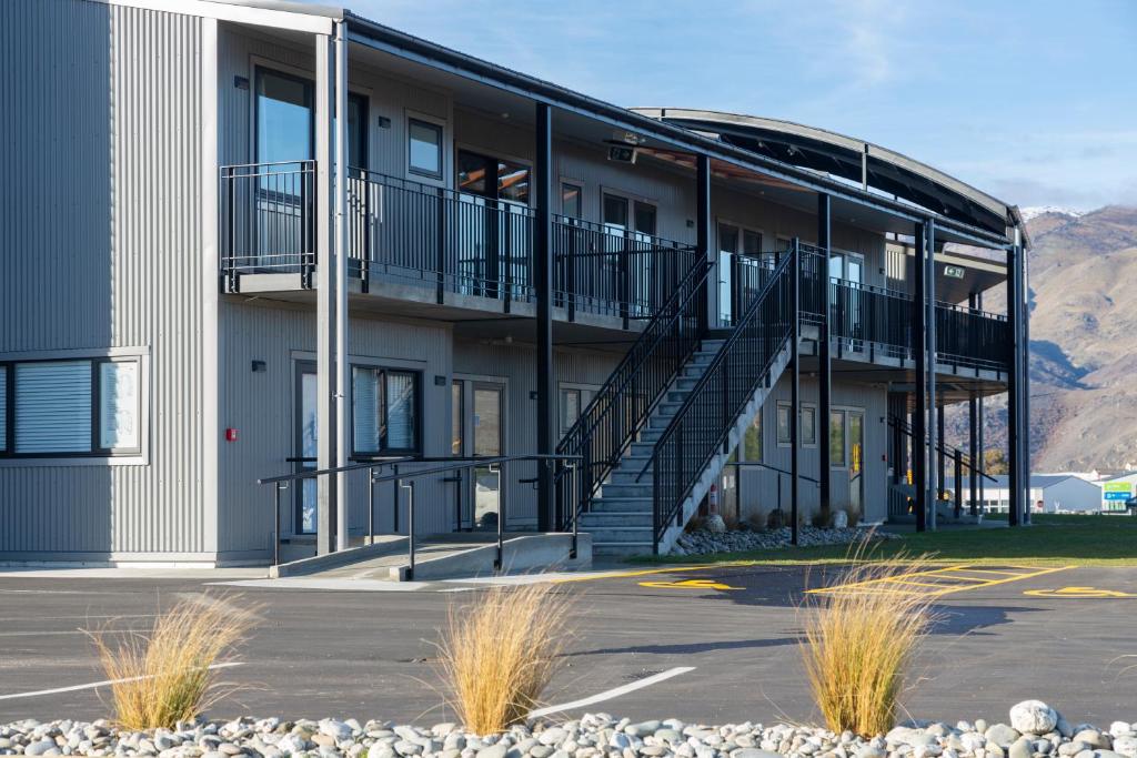 a building with a staircase in a parking lot at Harvest Park Studios Workers Accommodation in Cromwell