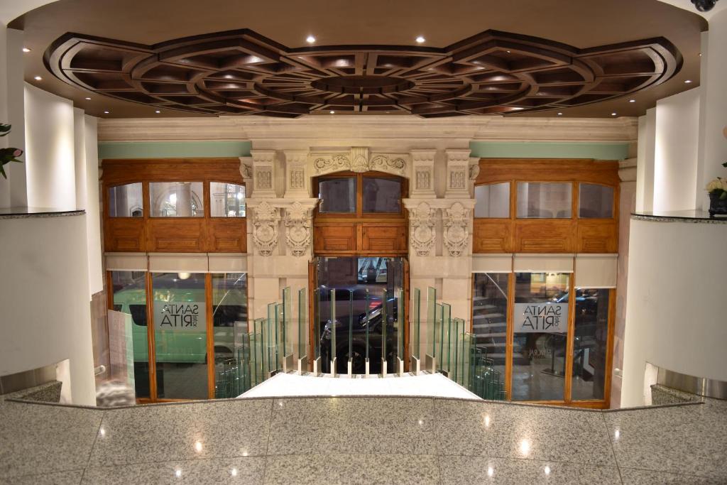 a lobby of a building with a ceiling at Santa Rita Hotel del Arte in Zacatecas