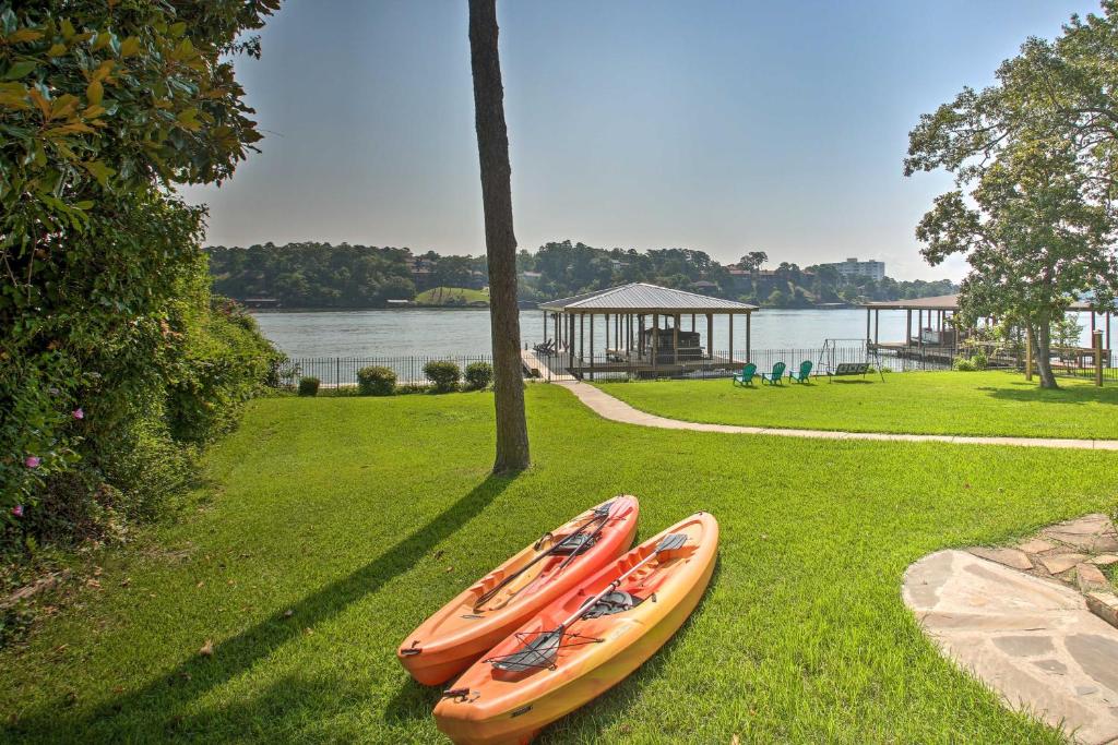 two kayaks sitting on the grass in a park at Lake Hamilton Family Escape with Kayaks, Dock, Grill in Hot Springs