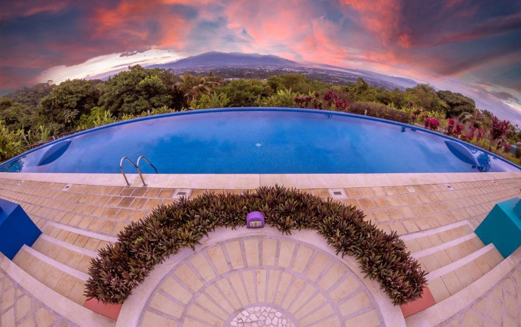 a large stone building with a blue sky at Xandari Resort & Spa in Alajuela