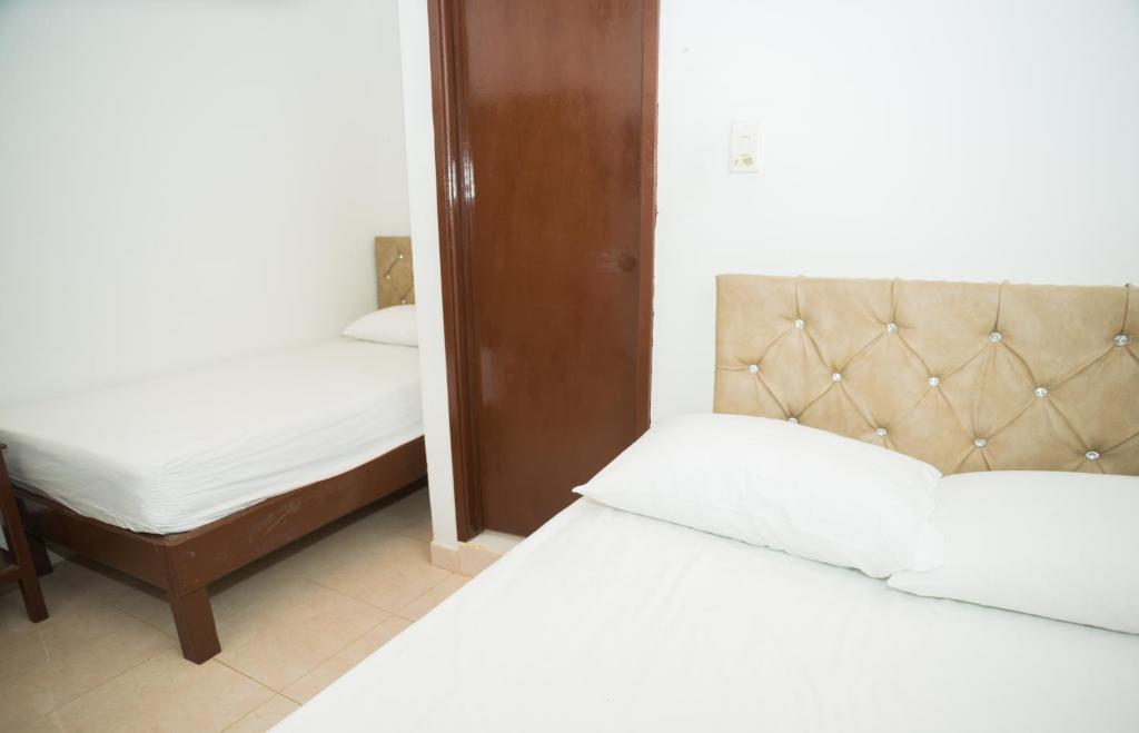 Postel nebo postele na pokoji v ubytování Hotel Clau