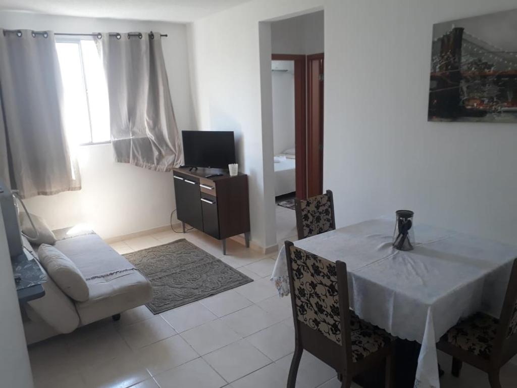 a living room with a table and a couch at Apto Oniz Campos X in Campos dos Goytacazes