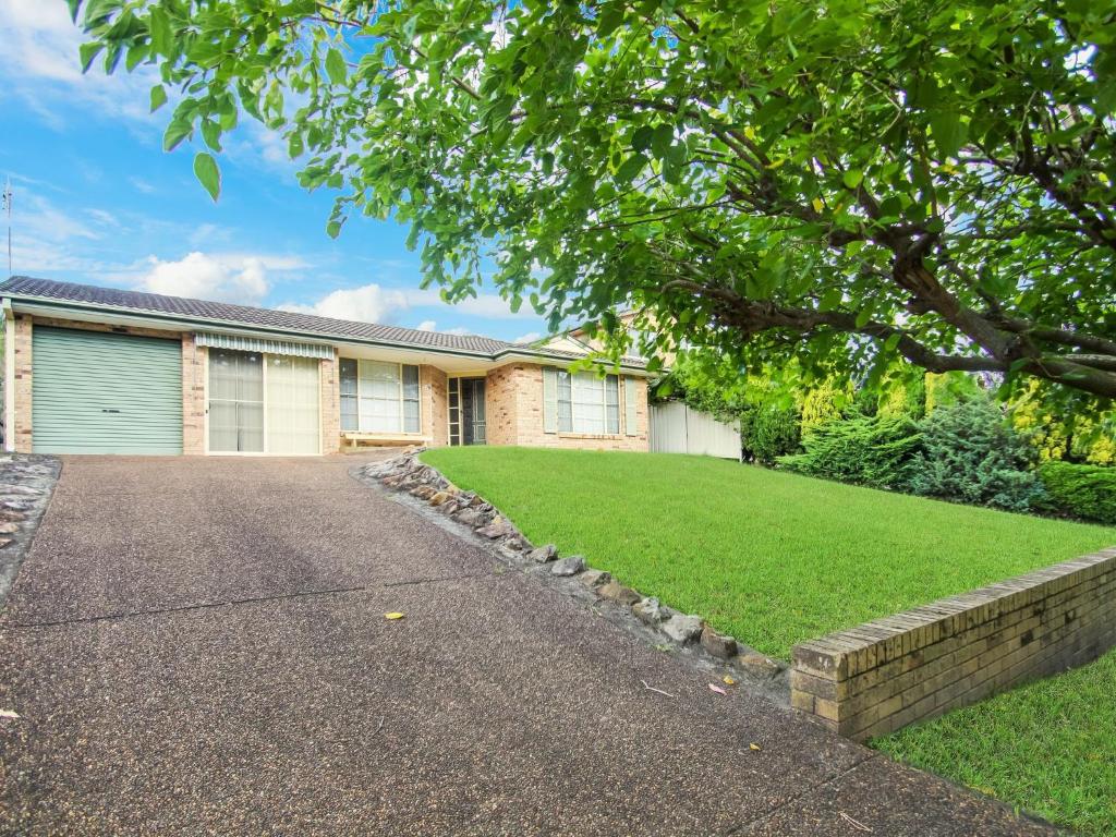 a house with a driveway in front of it at Peace by the Beach by Experience Jervis Bay in Vincentia