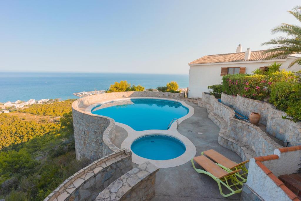 a swimming pool with a view of the ocean at Breizas in Alcossebre