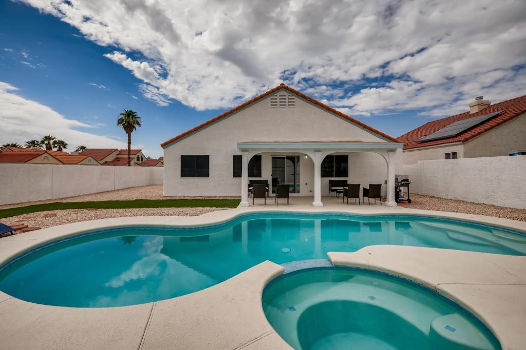 a swimming pool in front of a house at Luxurious House With A Pool, Spa, and Patio, Sleeps 6 Comfortably in Las Vegas