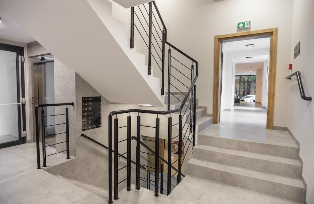 a staircase with black railings in a house at Hotel Alexander in Krakow