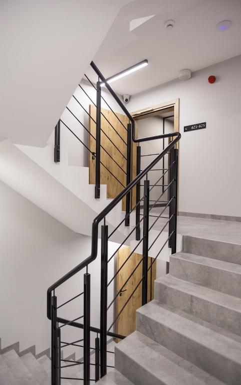 a staircase with metal railings and a wooden door at Hotel Alexander in Krakow