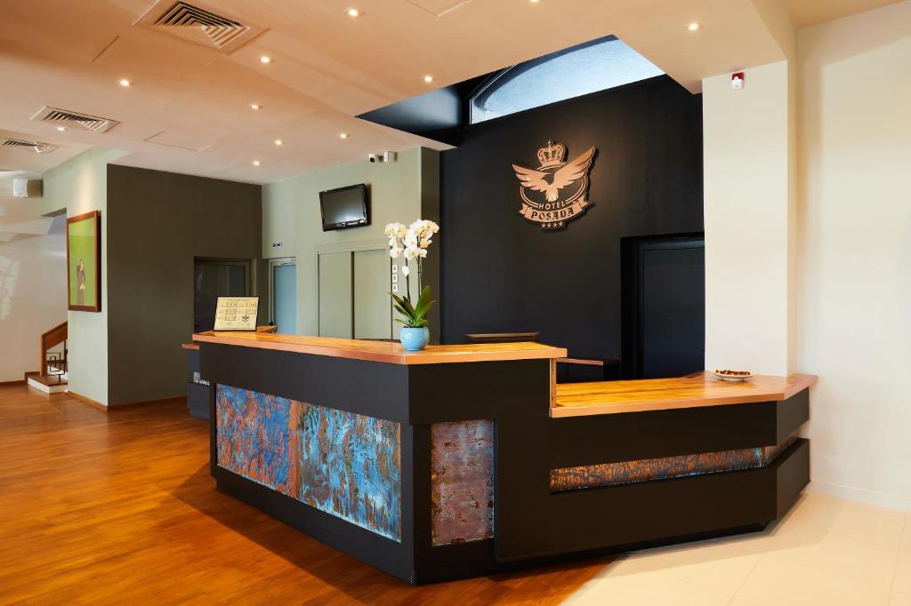 a cashier counter with a skull on the wall at Hotel Posada in Curtea de Argeş