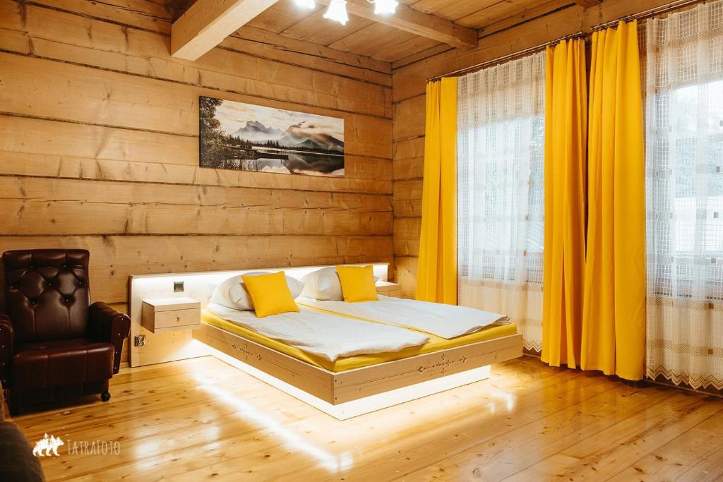 a bedroom with a bed and a chair in it at Schronisko Stary Młyn in Zakopane