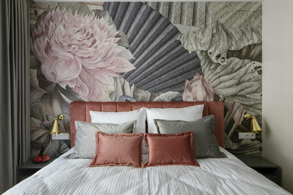 a bedroom with a bed with a floral wall mural at Flav Apartment in Krakow