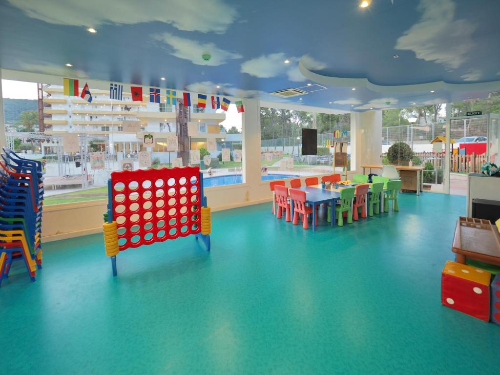 a childrens play area with colorful chairs and a pool at BQ Belvedere Hotel in Palma de Mallorca