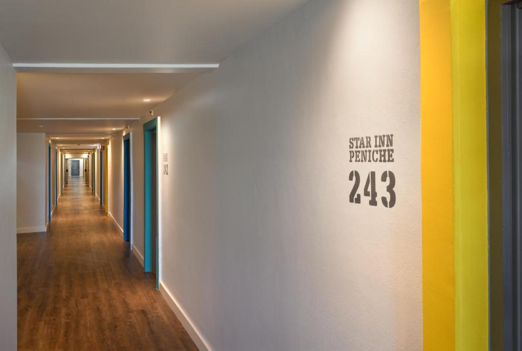a hallway with colorful walls and a sign on the wall at Star inn Peniche in Peniche