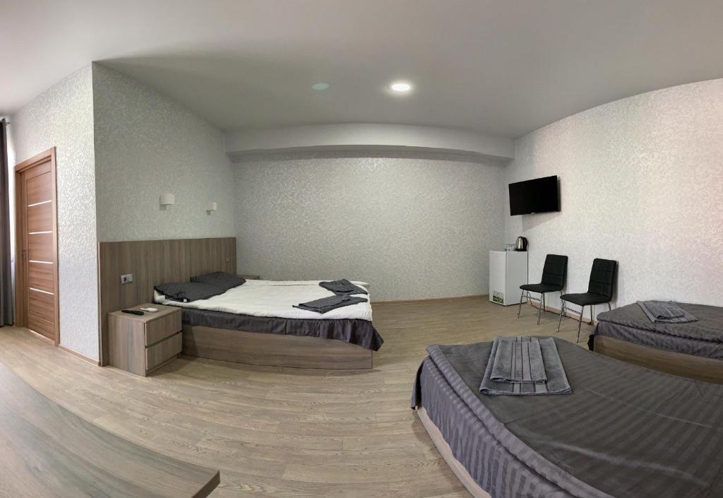 Postel nebo postele na pokoji v ubytování Hotel Voyage Вояж