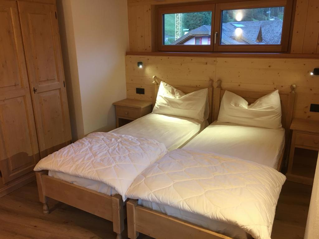 A bed or beds in a room at Appartamenti Cèsa Sorèie by AMA Val di Fassa
