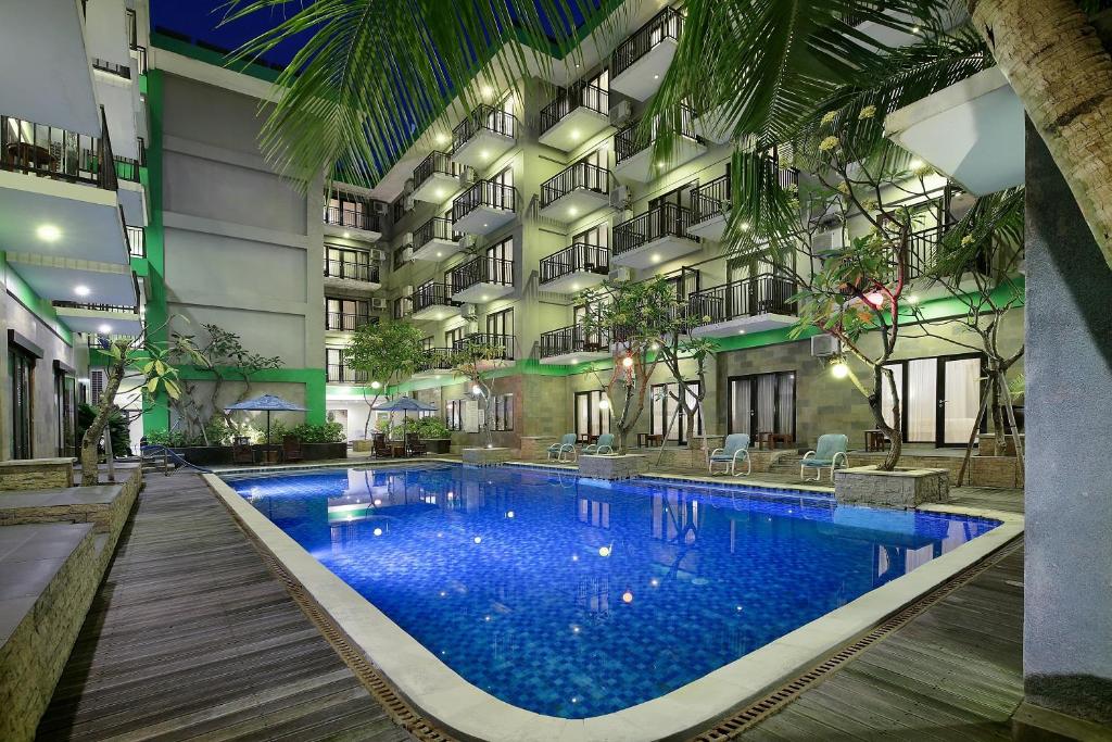 een groot gebouw met een groot zwembad bij Rofa Kuta Hotel - CHSE Certified in Legian