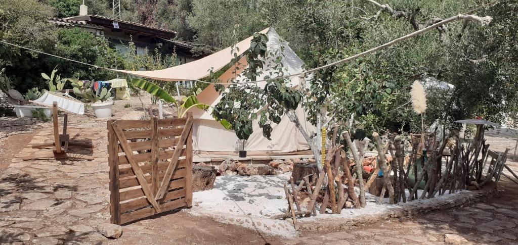 a tent with a fence and a wooden gate at Farm Glamping tent on Acquaviva Bay in Marittima