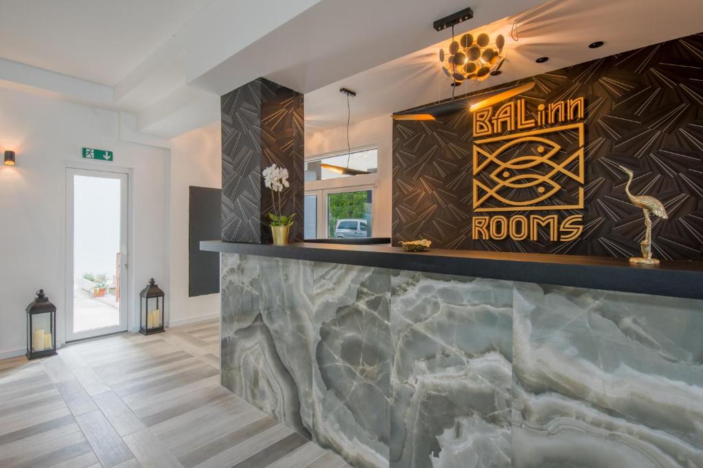 a bar in a house with a marble counter at Balinn rooms in Balatonszepezd