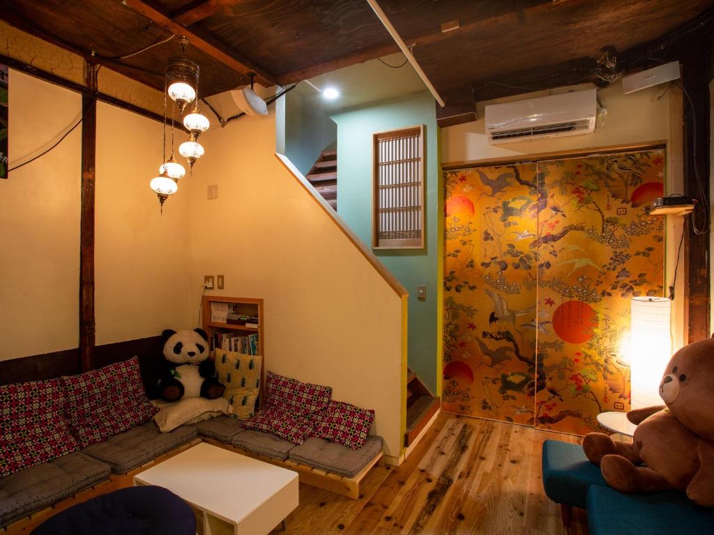 a childs room with a teddy bear and a crib at Himeji 588 Guest House in Himeji