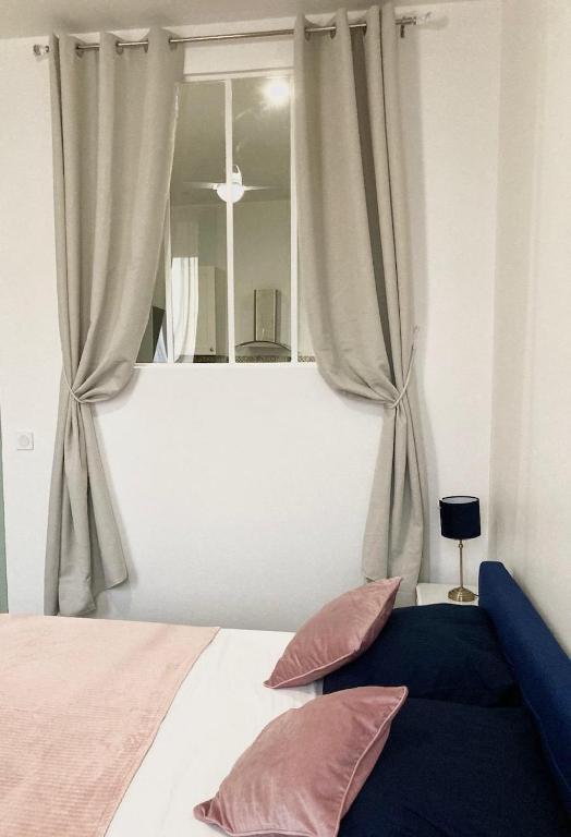 a bedroom with a bed with a large window at Charmant F4 proche de la gare Saint Charles in Marseille