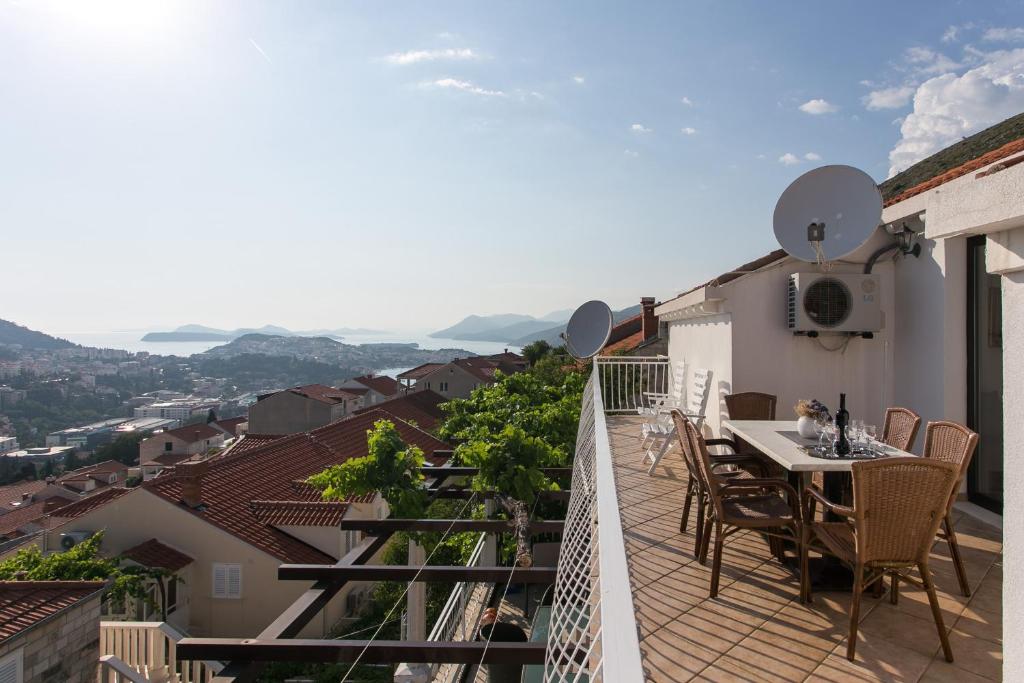 a balcony with a table and chairs on a building at Guest House Kono in Dubrovnik