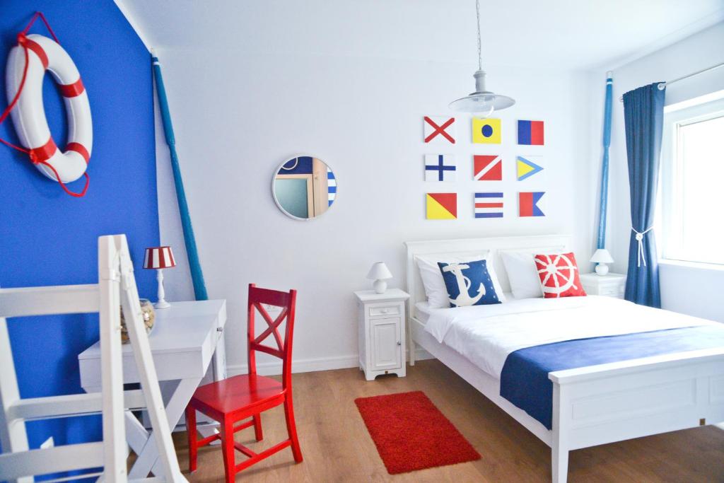 Dormitorio azul y blanco con cama y escritorio en Nautical rooms Old town, en Zadar