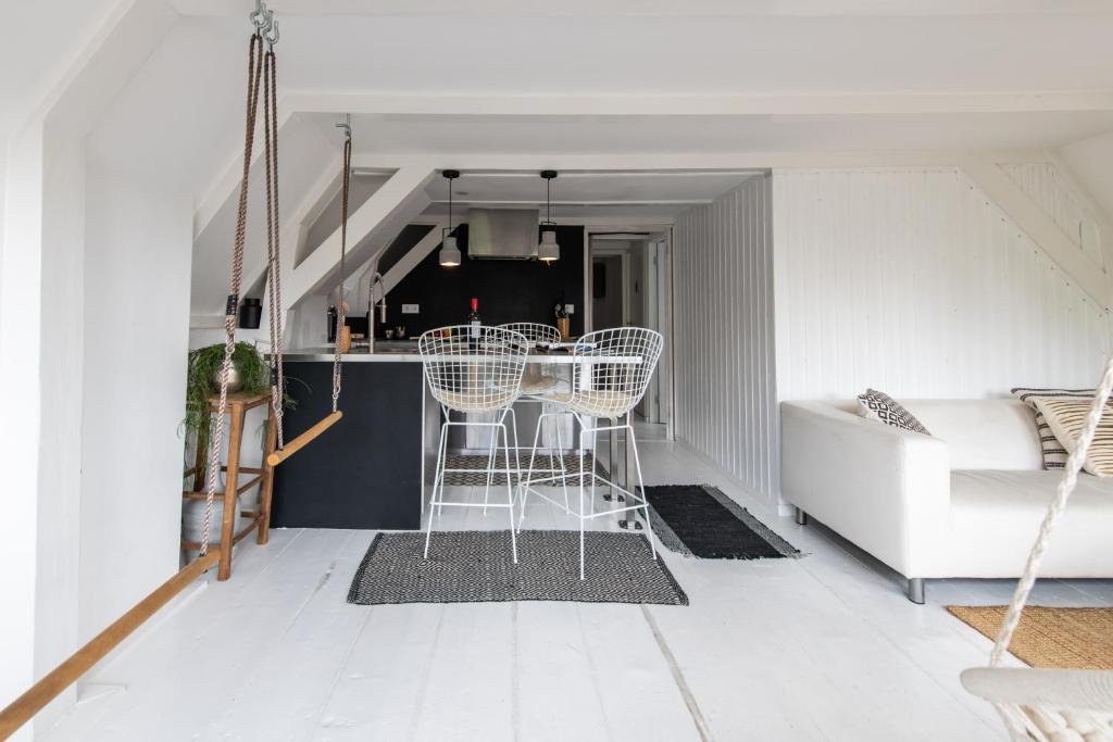 a white living room with a table and chairs at Two Rooms in City Centre in Amsterdam