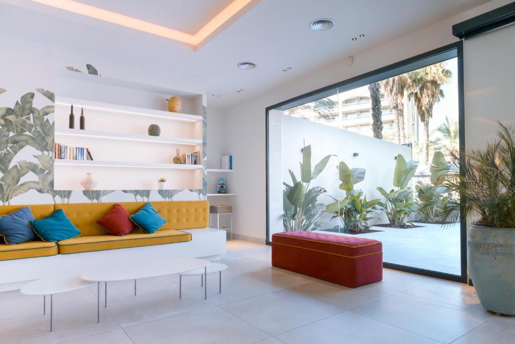 a living room filled with furniture and a large window at Apartaments Cye Salou in Salou