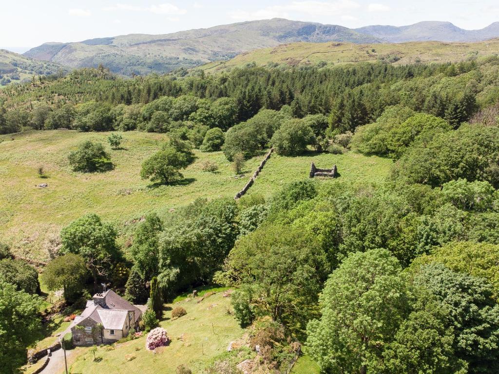 an aerial view of a field with trees and a house at Cae Lleci in Dolgellau