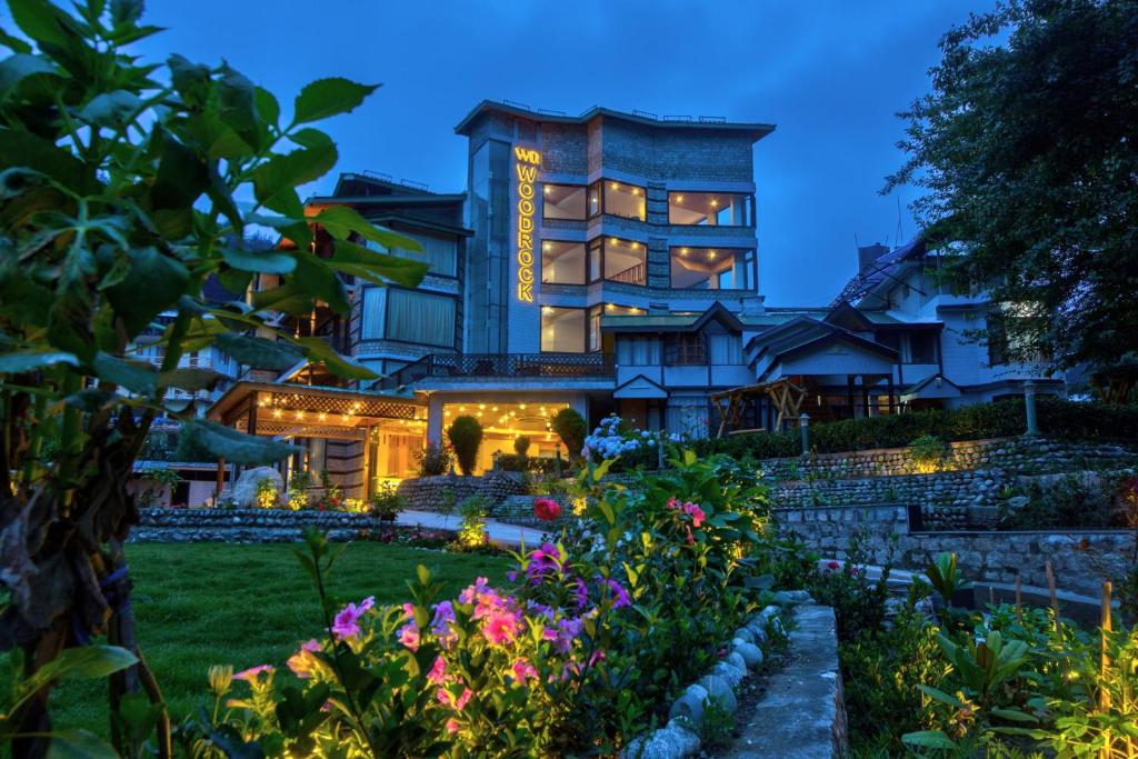 a house with a garden in front of it at Woodrock Luxury Botique Hotel in Manāli