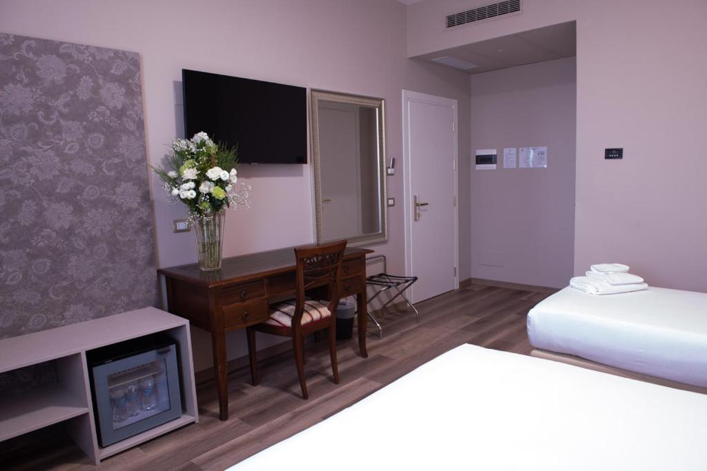 Postel nebo postele na pokoji v ubytování Hotel Della Rosa