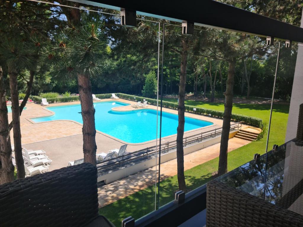 a view of a swimming pool from the balcony of a house at 365 apartmány LINEA in Piešťany