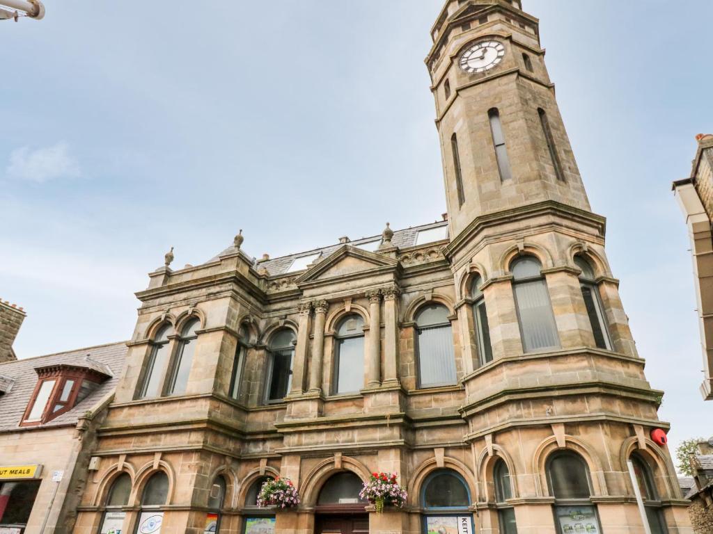 a building with a clock tower on top of it at Council Chambers at The Institute Executive Apartments in Keith