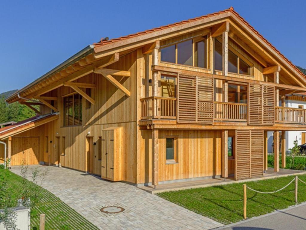 a large wooden house with a gambrel at Chalet an der Lofer in Reit im Winkl