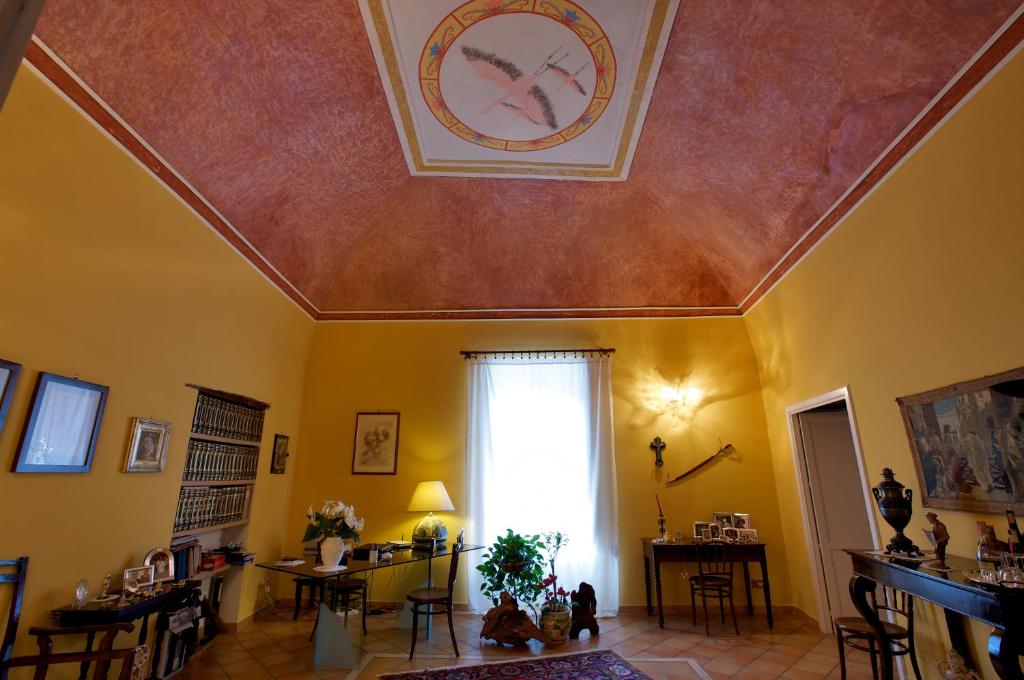 a living room with a clock on the ceiling at La Casa di Donn'Amelia in Vietri sul Mare