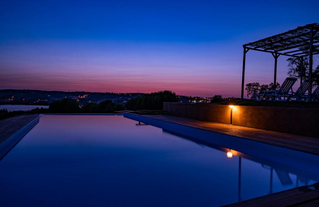 a swimming pool at night with the sky at Monte da Tojeirinha in Montargil